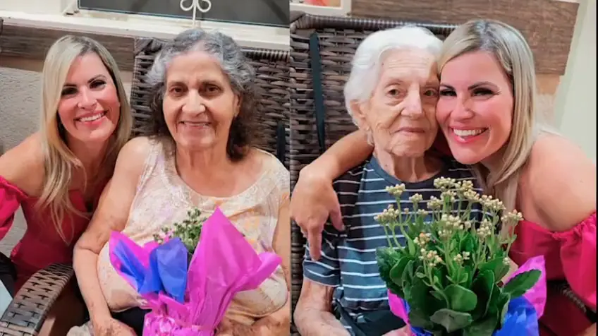 Duas senhoras com buquês de flores, abraçadas por duas mulheres mais jovens (primeiro quadro do vídeo)